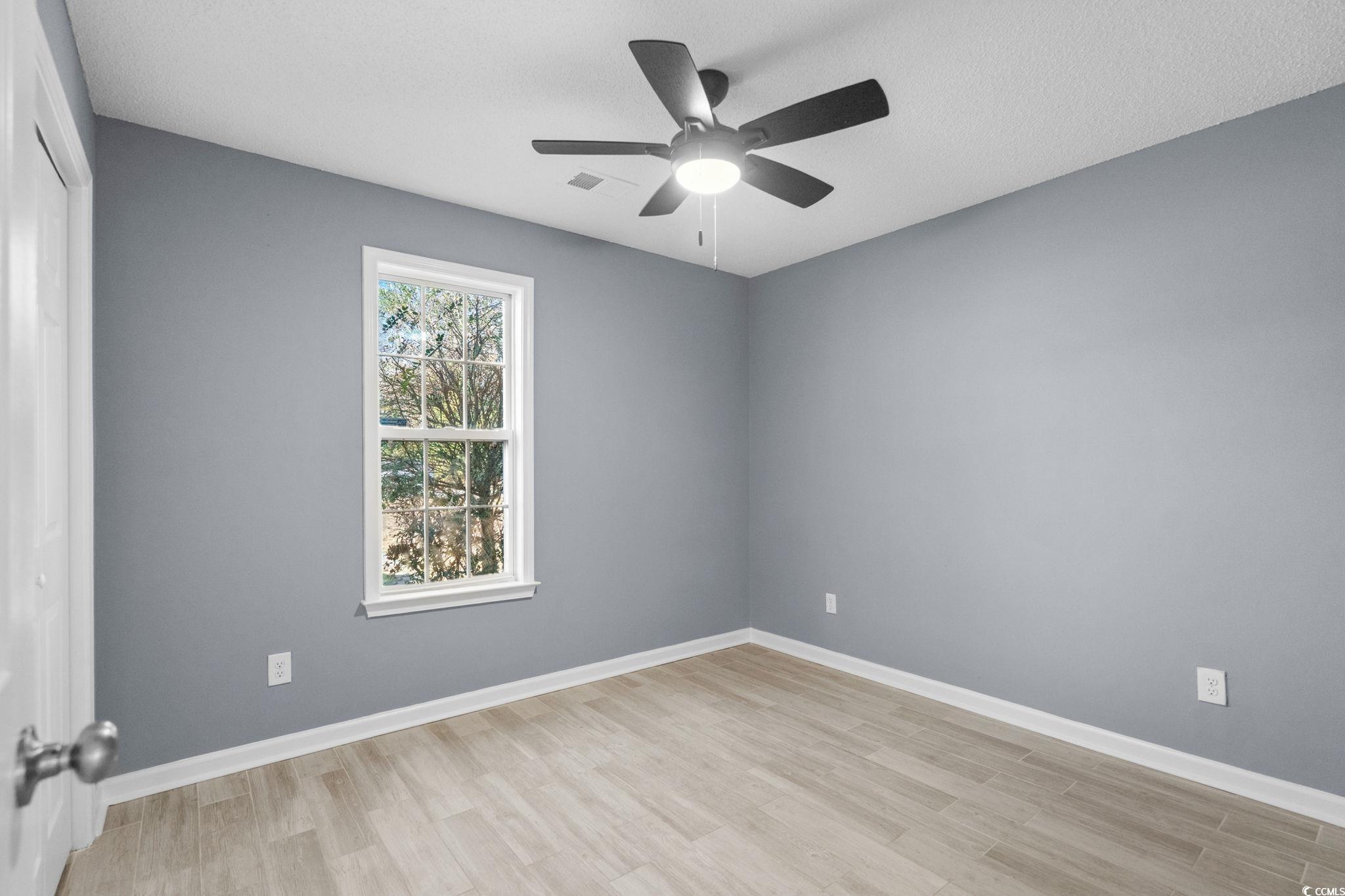 3343 New Road Conway, SC 29527 - Photo 20 of 36 Unfurnished room featuring light wood-style floors and ceiling fan