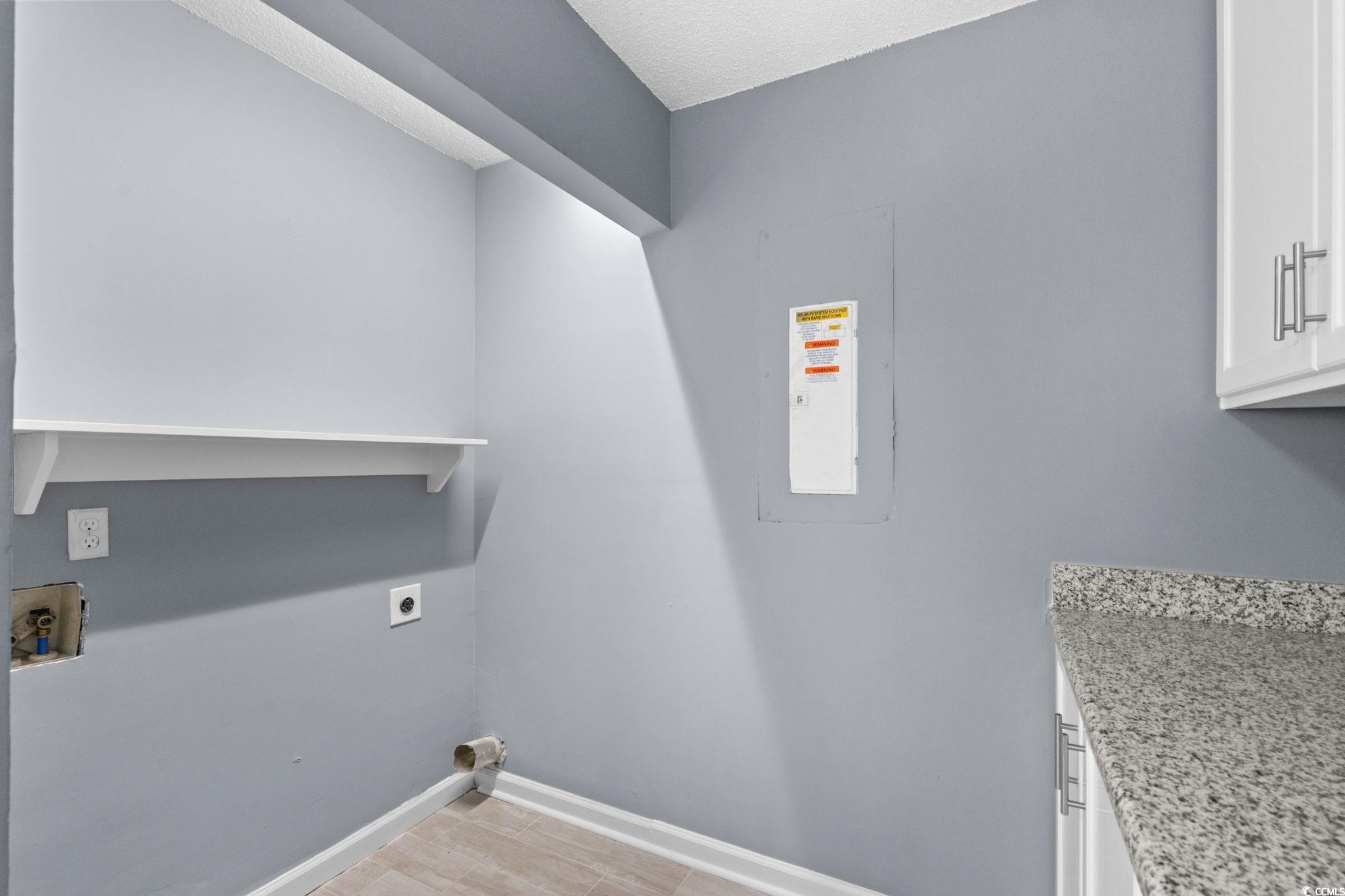 3343 New Road Conway, SC 29527 - Photo 23 of 36 Washroom featuring cabinet space, electric panel, electric dryer hookup, and washer hookup