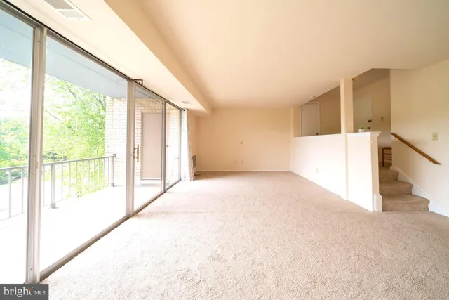 a view of an empty room and a window