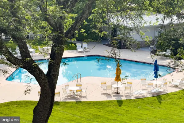 a view of a swimming pool with a yard