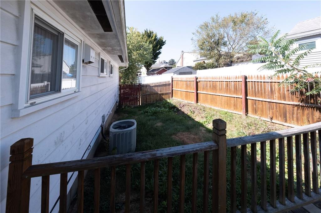 126 Chestnut Street Aliquippa, PA 15001 - Photo 13 of 22 a view of a brick house with a small yard and wooden floor and fence