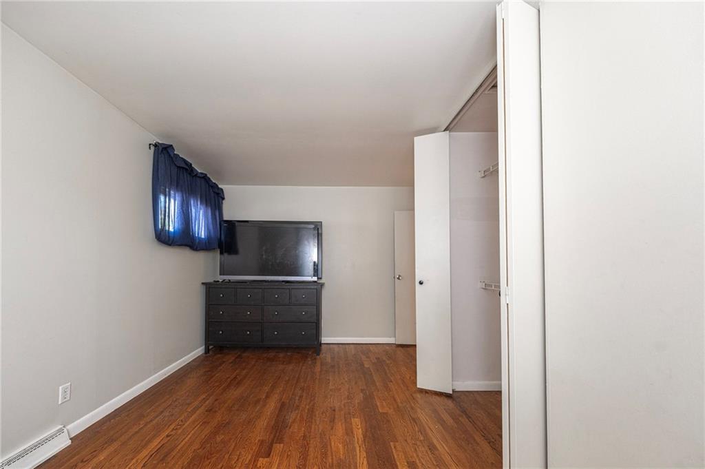 126 Chestnut Street Aliquippa, PA 15001 - Photo 5 of 22 a view of a livingroom with wooden floor and a refrigerator