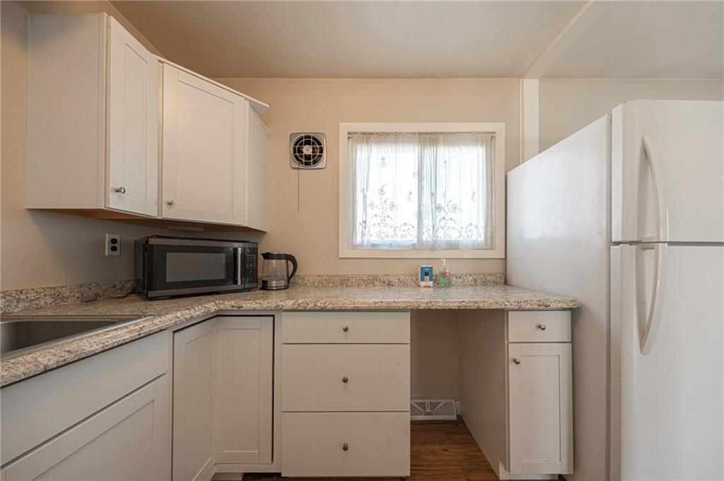 126 Chestnut Street Aliquippa, PA 15001 - Photo 9 of 22 a kitchen with granite countertop cabinets stainless steel appliances a sink and a window