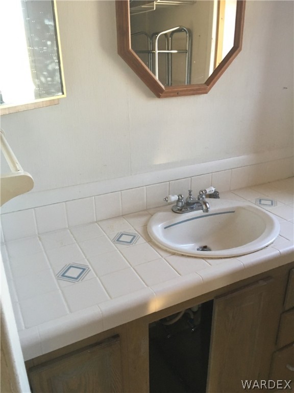 4238 West Ranch Road Golden Valley, AZ 86413 - Photo 21 of 45 a bathroom with a sink and a mirror