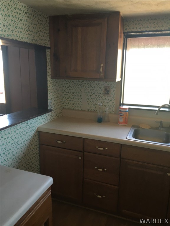 4238 West Ranch Road Golden Valley, AZ 86413 - Photo 24 of 45 a kitchen with a sink a window and cabinets