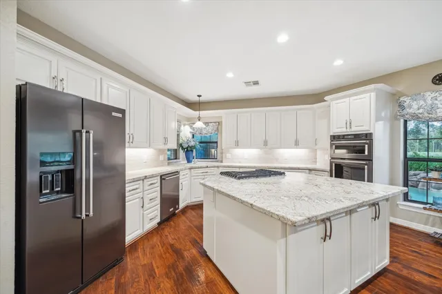 a kitchen with stainless steel appliances a refrigerator and a stove