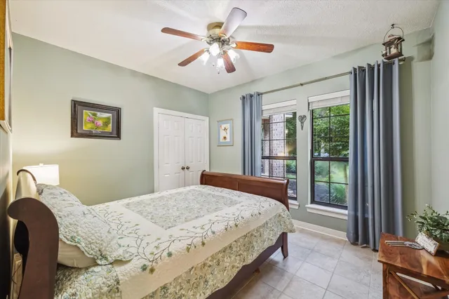 a bedroom with a large bed and a chandelier