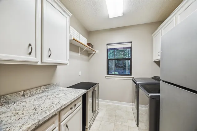 a kitchen with a sink cabinets and a window