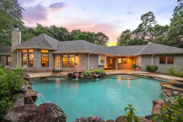 a front view of a house with swimming pool having outdoor seating