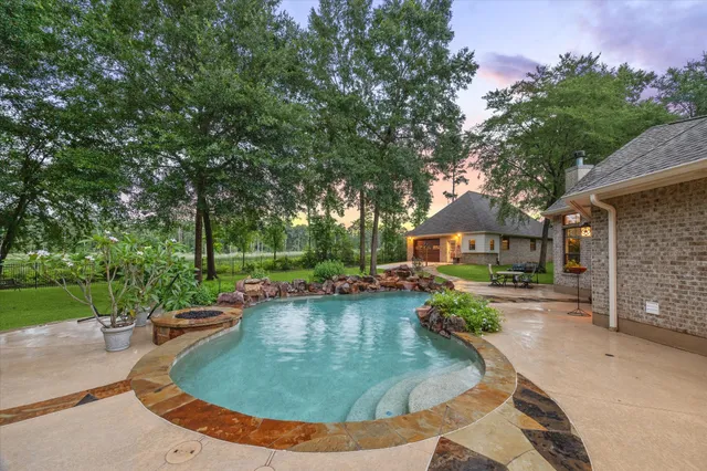 an aerial view of a house with swimming pool garden and patio