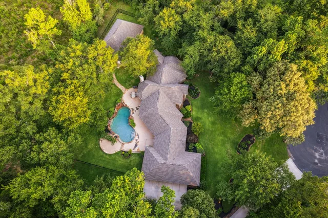 an aerial view of a house with a yard and lake view