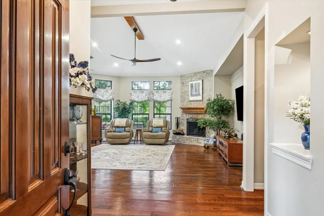 a very nice looking living room with a large window and wooden floor
