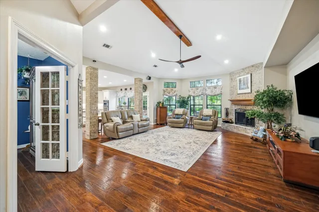 a living room with fireplace furniture and a flat screen tv