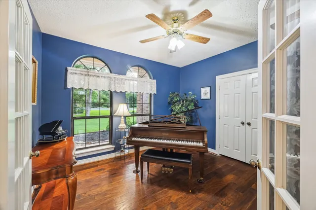 a living room with furniture and a wooden floor