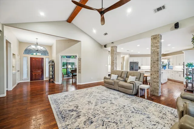 a living room with furniture and wooden floor