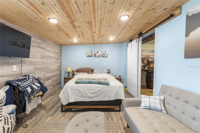 a bedroom with a bed and a television