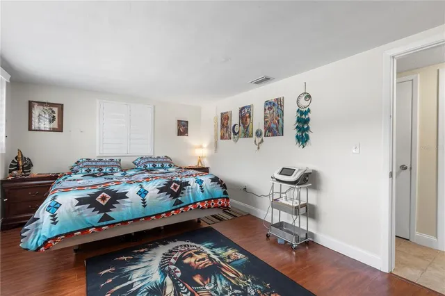 a bed room with furniture and paintings on the wall