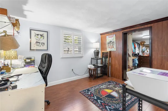 a living room with dining room furniture a rug and a window