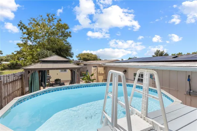 a view of a house with backyard porch and sitting area