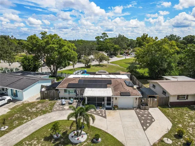 an aerial view of a kitchen with kitchen island and large trees