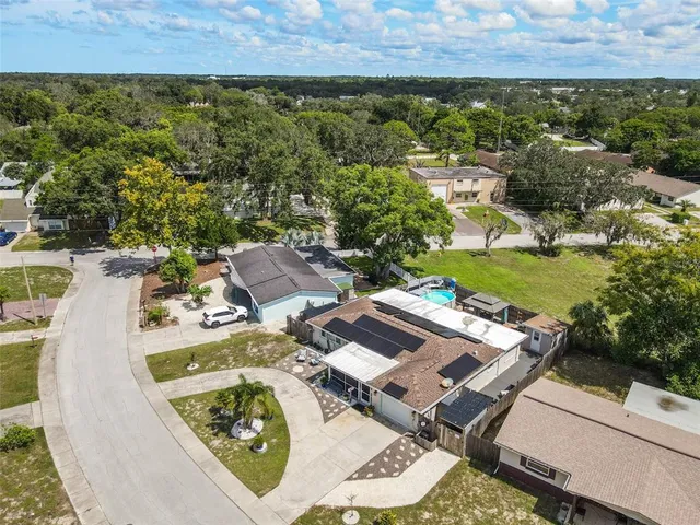 an aerial view of residential houses with outdoor space