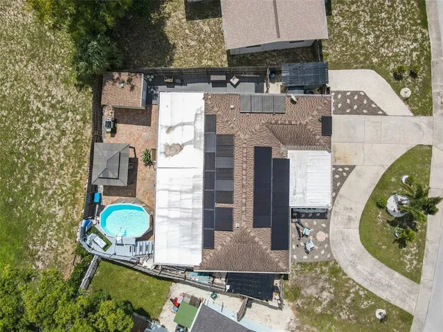 an aerial view of residential houses with outdoor space and lake view