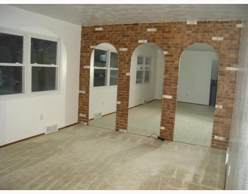 Living Room. Mirrors and windows bring an airy atmosphere to living area