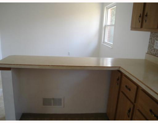 Kitchen. Convenient breakfast bar also shows the open dining area