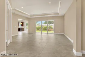 a view of a livingroom with wooden floor and a window