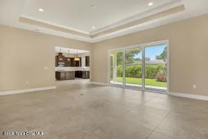 an empty room with fireplace and windows