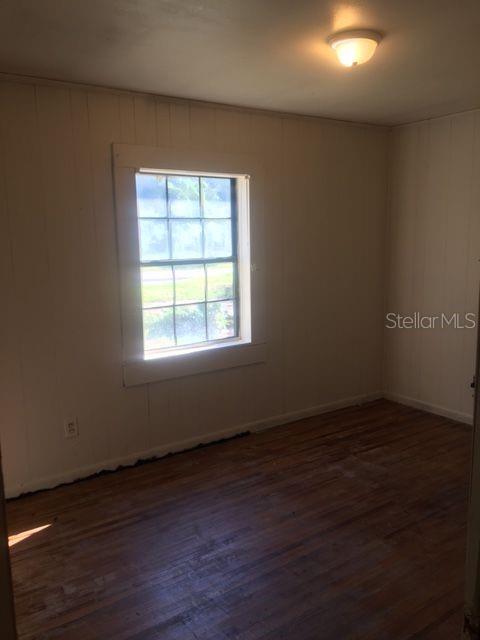 660 Poplar Street Monticello, FL 32344 - Photo 1 of 6 an empty room with wooden floor and windows