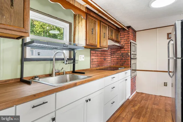 a kitchen with a sink and a refrigerator