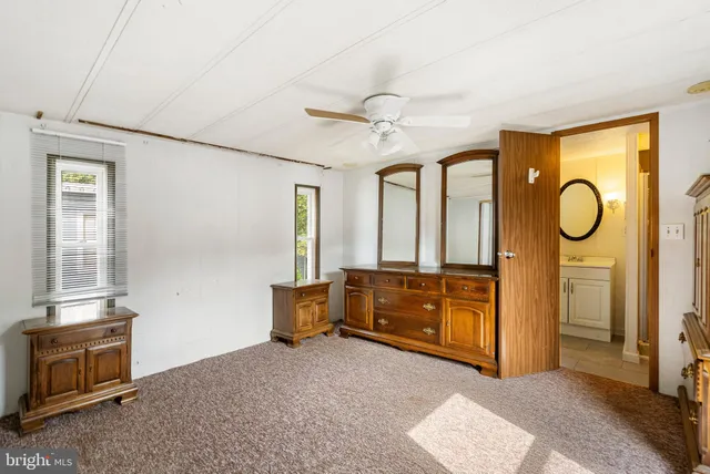 a bedroom with furniture and a window