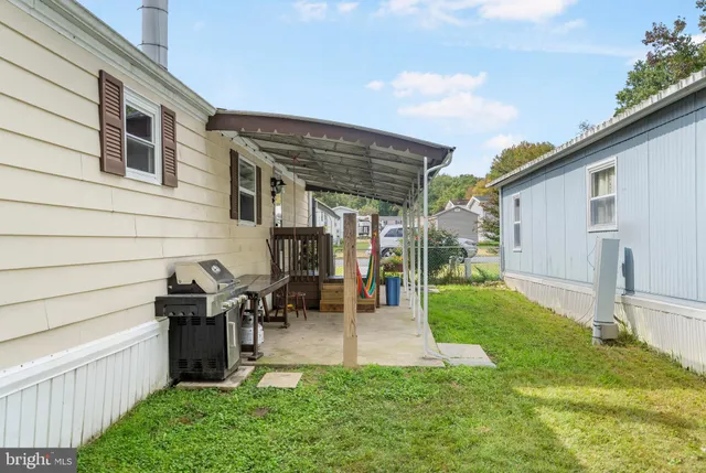 a backyard of a house with table and chairs