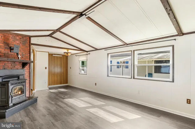 a view of empty room with window and fireplace