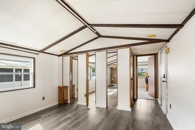 a view of hallway with wooden floor