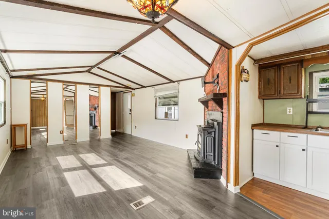a view of hallway with wooden floor and stairs