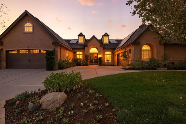 a front view of a house with a yard and garage