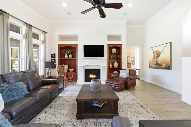 a kitchen with granite countertop white cabinets and a window