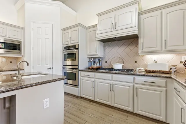 a dining room with furniture a chandelier and wooden floor