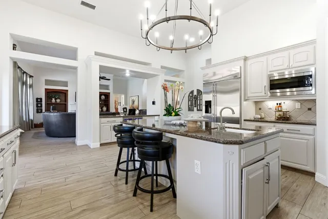 a view of a dining room with furniture and a chandelier