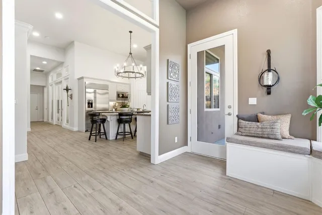 a bathroom with a granite countertop sink a toilet a mirror and shower