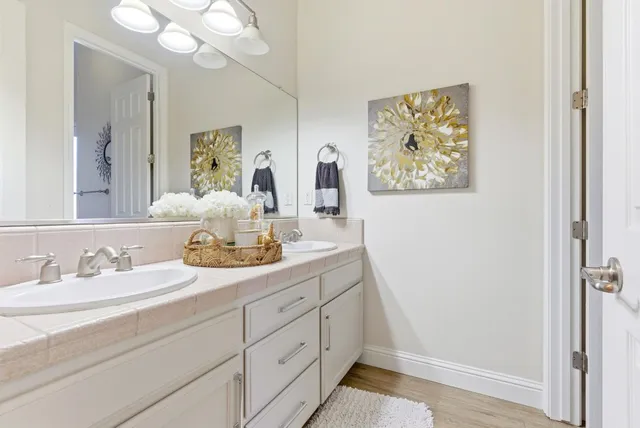 a very nice looking dining room with a large window and chandelier