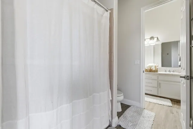 a bathroom with a tub a sink and a large mirror