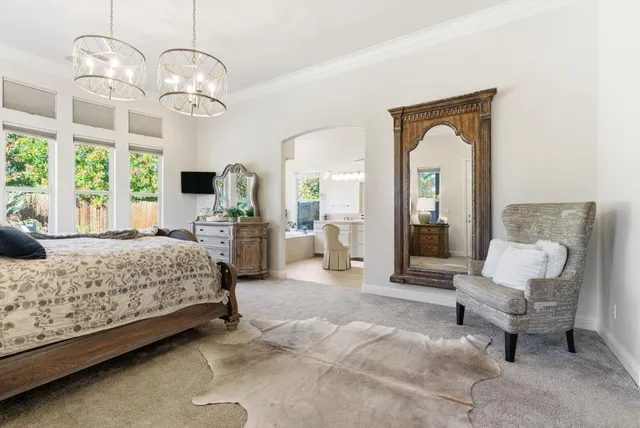 an aerial view of a house with a yard and wooden fence
