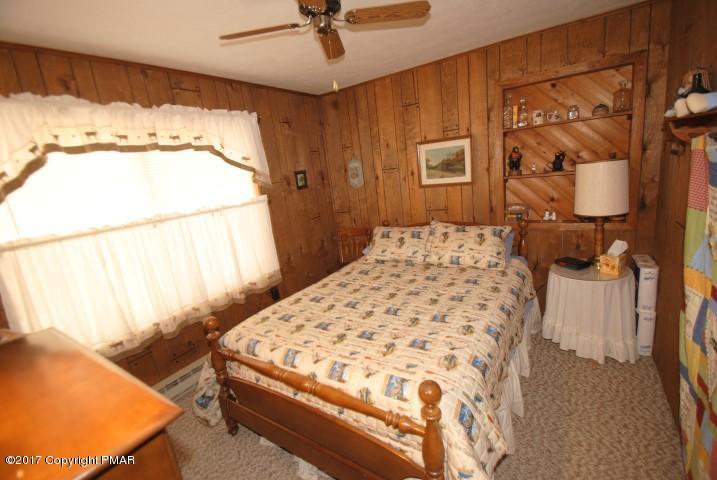 214 Elk Run Road Pocono Lake, PA 18347 - Photo 16 of 26 a bedroom with a bed and a window