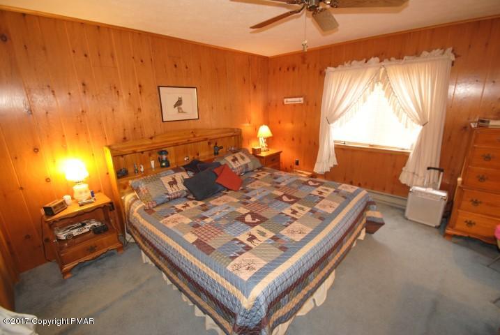 214 Elk Run Road Pocono Lake, PA 18347 - Photo 17 of 26 a bed sitting in a room next to a window
