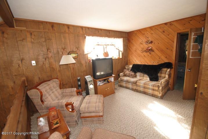 214 Elk Run Road Pocono Lake, PA 18347 - Photo 18 of 26 a living room with furniture and a window