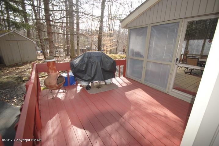 214 Elk Run Road Pocono Lake, PA 18347 - Photo 23 of 26 a view of a porch with a table and chairs