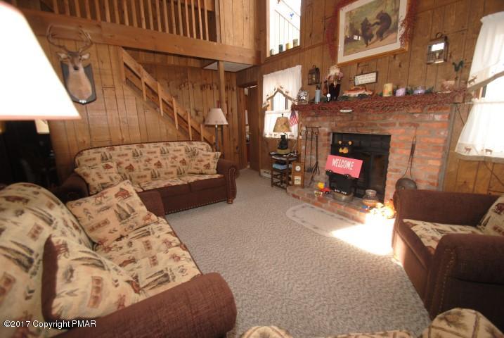 214 Elk Run Road Pocono Lake, PA 18347 - Photo 4 of 26 a living room with furniture and a fireplace